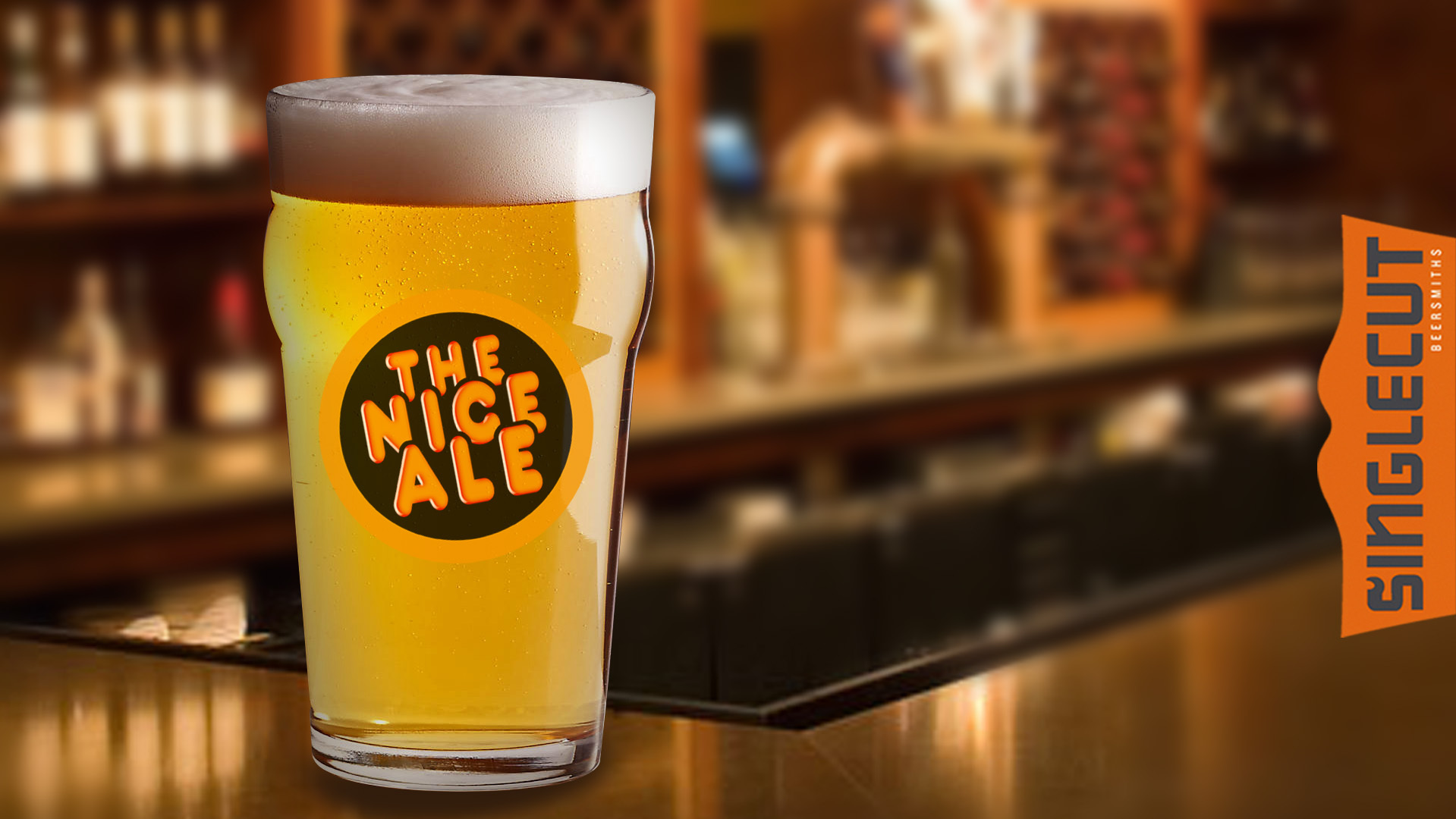 Full pint glass sitting on a brown bar top with a circular logo that says "The Nice Ale"